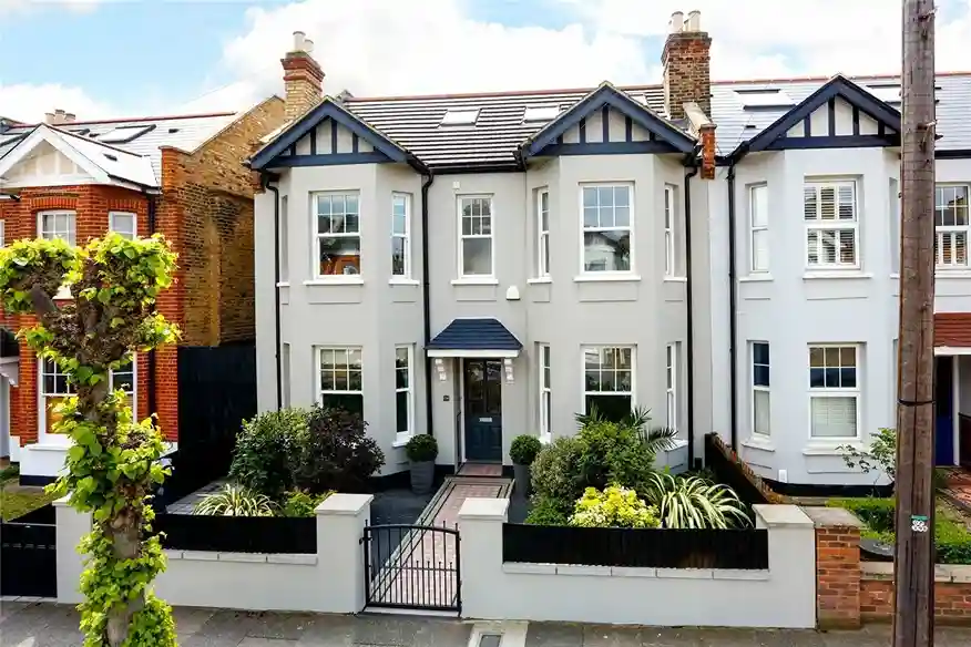 a house with a fence and plants property management in manchester