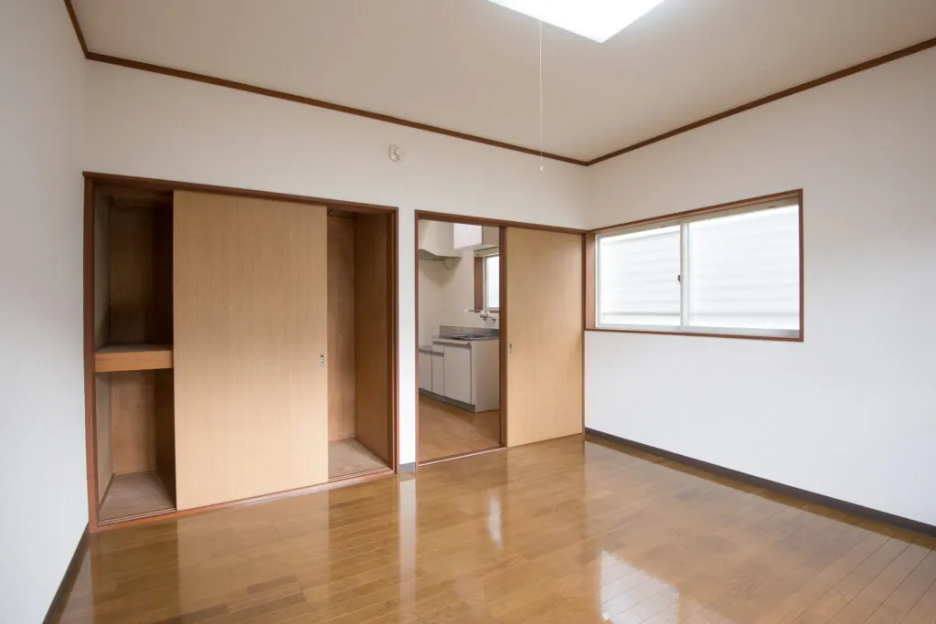 3. A vacant property management scene depicting an empty room with wooden flooring and a large skylight for natural light.